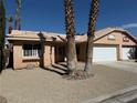 Inviting single-story home featuring a front yard with desert landscaping and a two-car garage at 254 Reber Dr, Mesquite, NV 89027