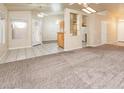 Open-concept living room showcasing neutral paint, plush carpet and natural light at 254 Reber Dr, Mesquite, NV 89027