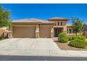 Beautiful single-story home featuring a three-car garage, desert landscaping, and a charming entryway at 3908 Specula Wing Dr, North Las Vegas, NV 89084