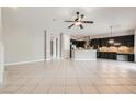 Spacious living room featuring an open concept with a kitchen and tile floors at 3908 Specula Wing Dr, North Las Vegas, NV 89084