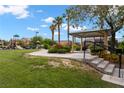 Picturesque community park offers playground, picnic area, and grassy lawns under a bright sky at 6045 Riverwalk Falls St # 102, North Las Vegas, NV 89031