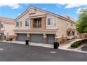 Three car garage exterior showcasing contemporary design and well-maintained landscaping at 6045 Riverwalk Falls St # 102, North Las Vegas, NV 89031