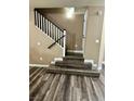 Inviting staircase featuring modern wood-look flooring and a classic white railing at 6045 Riverwalk Falls St # 102, North Las Vegas, NV 89031