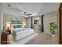 Comfortable bedroom with plush carpet, a ceiling fan, and ample natural light creating a relaxing retreat at 6361 W Viking Rd, Las Vegas, NV 89103