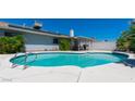 A private pool on a sunny day with clear blue water and solar panels on the roof at 6361 W Viking Rd, Las Vegas, NV 89103