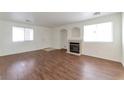 Well-lit living room features hardwood floors, fireplace, and access to the front entrance at 10673 Alondra Peak St, Las Vegas, NV 89183
