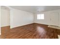 Open living room with hardwood floors and lots of natural light at 10673 Alondra Peak St, Las Vegas, NV 89183