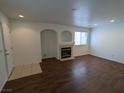 Cozy living room featuring recessed lighting, wood floors, a fireplace, and neutral paint at 10673 Alondra Peak St, Las Vegas, NV 89183