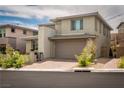 This is a modern two-story home featuring a two-car garage and desert landscaping at 12495 Point Sierra St, Las Vegas, NV 89138