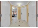 View of tiled hallway with multiple doors and an opening to the suite's seating area at 125 E Harmon Ave # 2215, Las Vegas, NV 89109