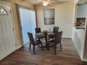 Dining area boasts wood floors, a modern table set, and natural light at 1450 Hialeah Dr # D, Las Vegas, NV 89119