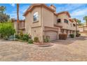 Charming townhouse complex with desert landscaping, brick pavers, and multiple car garages at 2050 W Warm Springs Rd # 1822, Henderson, NV 89014