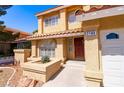 Inviting front entrance with a stone planter and decorative accents, enhancing curb appeal at 2105 Harbor Cliff Dr, Las Vegas, NV 89128