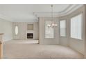 Bright living room with neutral carpet, cozy fireplace, and natural light from multiple windows at 232 Morgyn Ln # 6, Boulder City, NV 89005