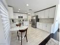 Modern kitchen featuring stainless steel appliances, white cabinets, and marble countertops at 2429 Worchester Rd, Henderson, NV 89074