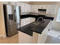 Bright kitchen featuring modern stainless steel appliances and black countertops at 3641 Spring Day Ct, Las Vegas, NV 89147