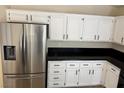 Kitchen with modern stainless steel refrigerator and white cabinets with black hardware at 3641 Spring Day Ct, Las Vegas, NV 89147