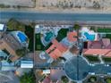 Expansive aerial view of a property featuring multiple pools, a putting green, and a well-maintained yard at 4061 W Eldorado Ln, Las Vegas, NV 89139