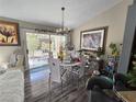 Bright dining area featuring modern lighting, stylish decor, and sliding glass doors to the outdoor patio at 415 Golden State St, Henderson, NV 89012