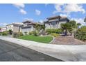 Beautiful single-story home featuring lush landscaping and a well-manicured lawn at 4430 Angelo Rosa St, Las Vegas, NV 89135