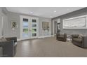 Spacious foyer with herringbone floors, neutral walls, and elegant furnishings at 4430 Angelo Rosa St, Las Vegas, NV 89135