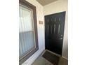 Exterior view of the front door and adjacent window, complete with a welcome mat and unit number 1321 at 45 Maleena Mesa St # 1321, Henderson, NV 89074