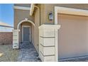Close-up of the front entrance and garage, highlighting the neutral color palette at 5556 Cornadelo Range Rd, Las Vegas, NV 89113