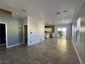 Open-concept layout with tiled floors, designer accent wall, recessed lighting, and seamless transition to the kitchen at 5846 Lee Fairy Ct, Las Vegas, NV 89139
