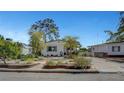 Well-maintained single story home showcasing charming landscaping, driveway and mature trees at 619 D Avenue, Boulder City, NV 89005