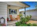 Charming front porch featuring rocking chairs and space to relax on the tiled floor, inviting curb appeal at 619 D Avenue, Boulder City, NV 89005