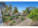 Beautifully landscaped front yard of single story home with walkway, gravel and flowering plants at 619 D Avenue, Boulder City, NV 89005