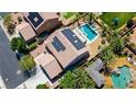 An aerial view showcases the home's pool, spa, solar panels, and landscaped backyard at 6489 Crest Estates St, Las Vegas, NV 89131