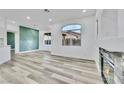 Open concept living room with hardwood floors, fireplace, and accent wall at 7909 Smokey Ridge Ct, Las Vegas, NV 89131