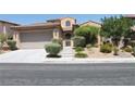 Tan two-story home with well-manicured landscaping at 932 Tafalla Ct, Las Vegas, NV 89138