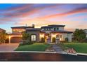 Elegant single-Gathering home with lush landscaping, stone accents, and a grand entrance at sunset at 10 Olympia Outlook Dr, Las Vegas, NV 89141