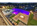Aerial view of a backyard featuring a uniquely shaped pool with a built-in fire pit and seating area, perfect for entertaining at 10 Olympia Outlook Dr, Las Vegas, NV 89141