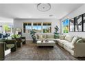 Spacious living room with large windows, comfortable seating, and stylish decor at 10305 Turia Gardens Rd, Las Vegas, NV 89135