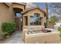 Inviting front porch with seating area, desert landscaping, and a Ring doorbell security system at 10325 Falls Church Ave, Las Vegas, NV 89144