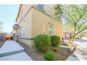 Attractive two-story home featuring manicured landscaping with lush shrubbery, and a serene, park-like atmosphere at 1035 Spotted Saddle St, Henderson, NV 89015
