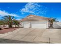 Charming single story home with a tile roof, mature palm tree and a two car garage at 1066 Vanlier Ln, Henderson, NV 89015