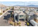 Charming two-story home with a well-manicured front yard and a convenient two-car garage at 10830 Space Odyssey Ave, Las Vegas, NV 89129