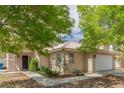 Inviting single-story home with desert landscaping, covered entry, and attached two-car garage at 1133 Mount Olympias Ct, Las Vegas, NV 89110