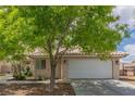 Charming single-story home features a tile roof, desert landscaping, and a two-car garage at 1133 Mount Olympias Ct, Las Vegas, NV 89110
