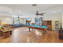 Spacious living room with hardwood floors, ceiling fans, a billiard table and ample natural light at 1200 I Ave, Boulder City, NV 89005