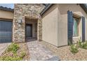 Close up of the main entrance showing the stone facade and a brick walkway at 138 Crimson Cactus Ave, Henderson, NV 89011