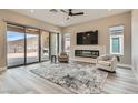 Bright living room with a modern fireplace and a sliding glass door to a covered patio at 138 Crimson Cactus Ave, Henderson, NV 89011