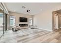 Spacious living room with fireplace, recessed lighting, ceiling fan, and wood flooring at 138 Crimson Cactus Ave, Henderson, NV 89011