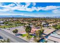Wide aerial shot of a residential area featuring tree-lined streets and the property's expansive lot at 1410 E Serene Ave, Las Vegas, NV 89123