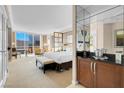 Bright bedroom features a comfortable bed, sitting area, and expansive windows offering city views at 145 E Harmon Ave # 2411, Las Vegas, NV 89109