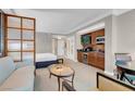 Living room featuring wood trim, television, and coffee/wine bar at 145 E Harmon Ave # 2411, Las Vegas, NV 89109